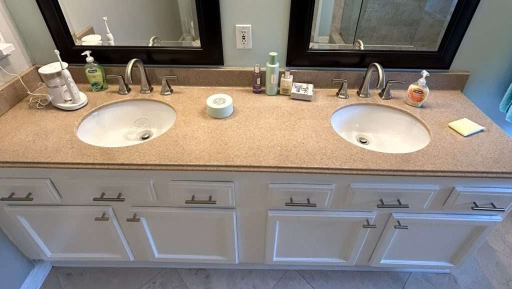 Completed kitchen and bathroom remodeling near Orange Park FL, featuring elegant finishes, dual sinks, and updated fixtures that enhance both the functionality and design of the space.